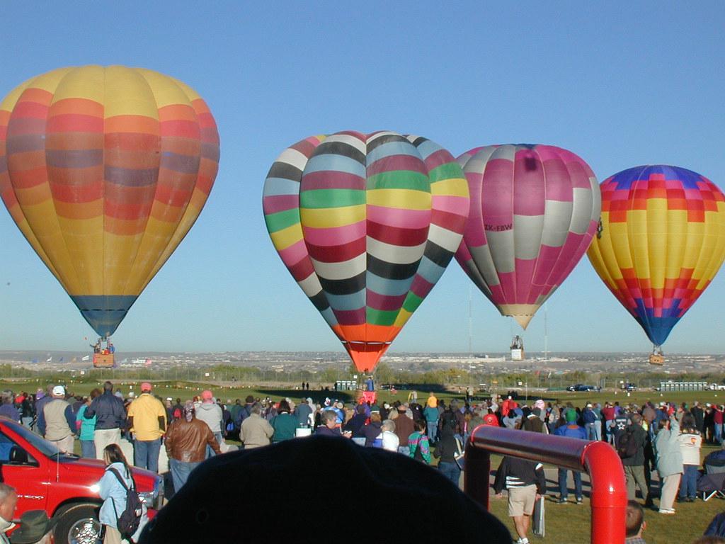 A collection of printed event photos showcasing various Albuquerque events and celebrations