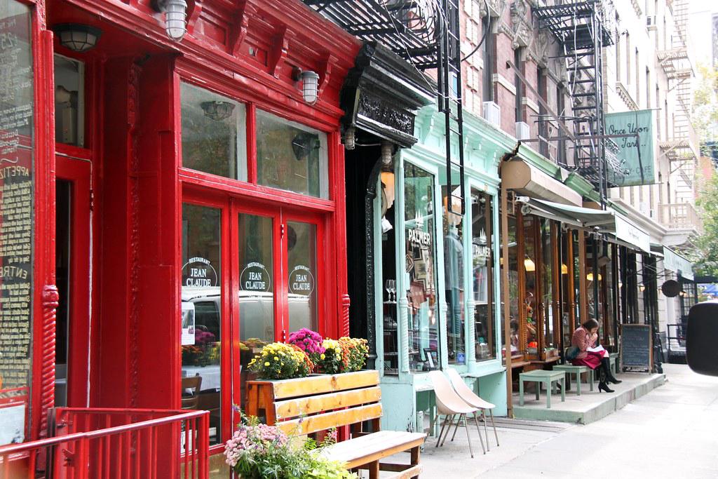 Charming storefronts and cafes in the Bishop Arts District with people browsing and dining