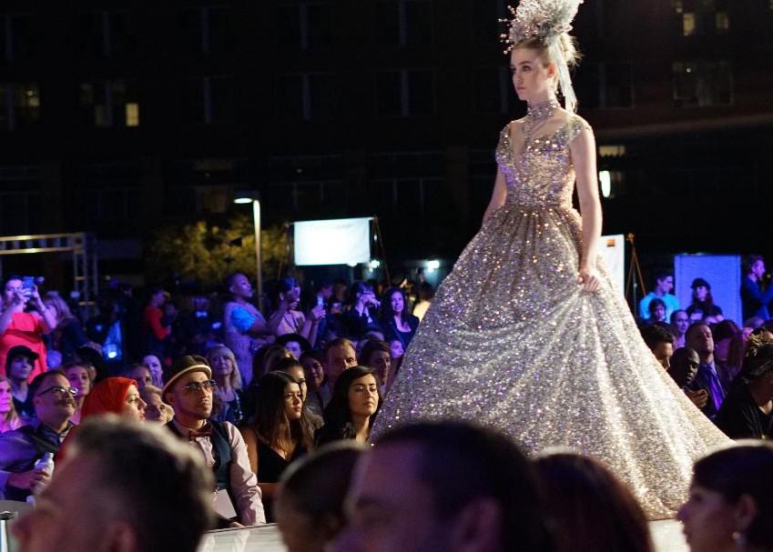 A photojournalist capturing a diverse runway show during Chicago Fashion Week