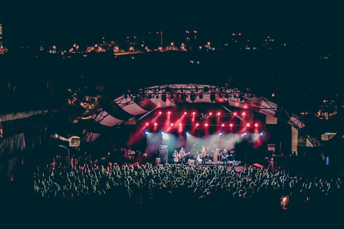 A montage of concert lighting effects, showcasing various colors and patterns used in live performances