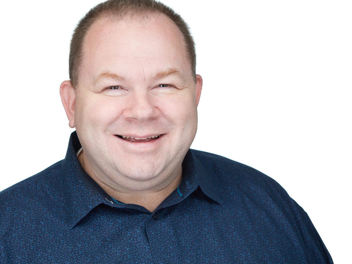 A confident and approachable professional posing for a headshot