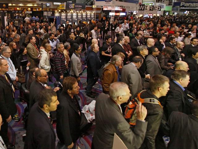A corporate event photographer capturing a diverse crowd at a trade show in Atlanta
