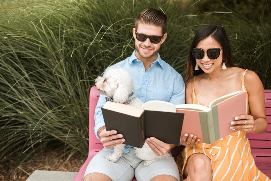 A couple incorporating personal elements into their engagement photo shoot, including their dog and favorite books