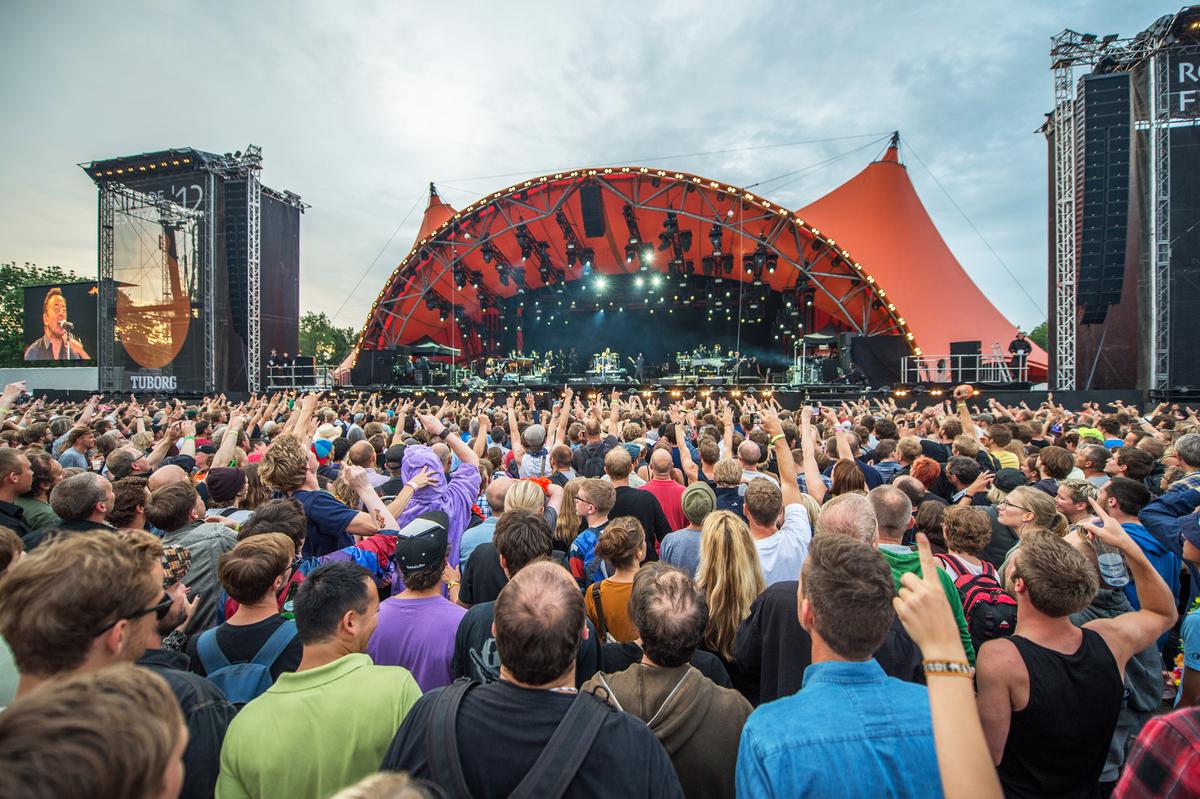 A collage of diverse festival scenes including a music stage, film screening, and cultural parade