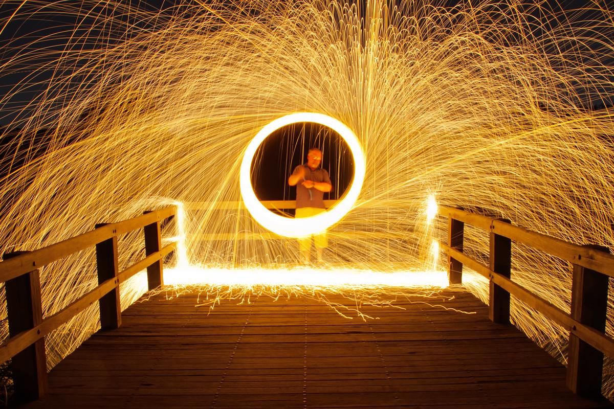 A photographer using light painting technique at an event
