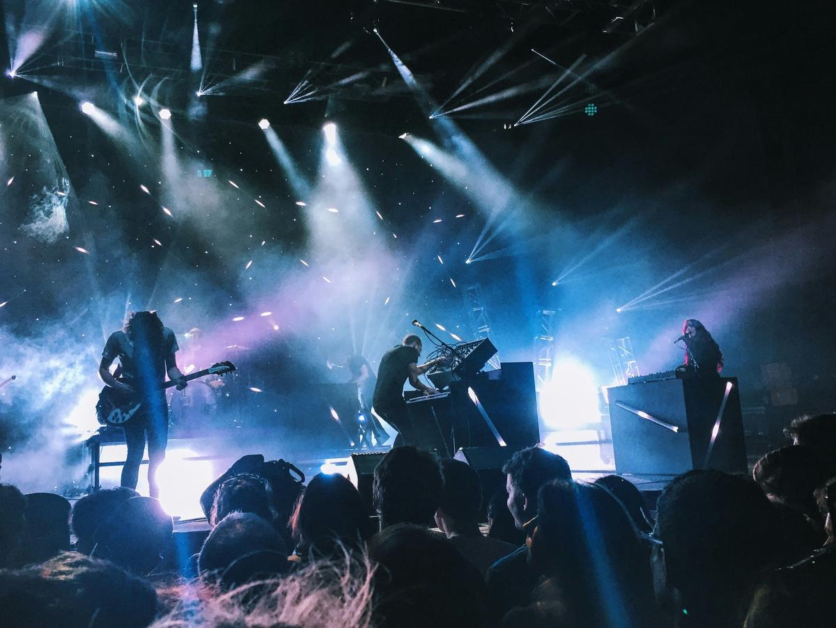 An energetic live music performance at George's Majestic Lounge with dynamic stage lighting