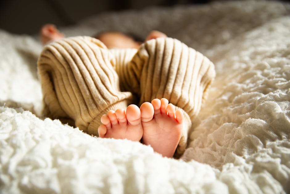 A newborn baby being photographed at home in a natural, relaxed setting