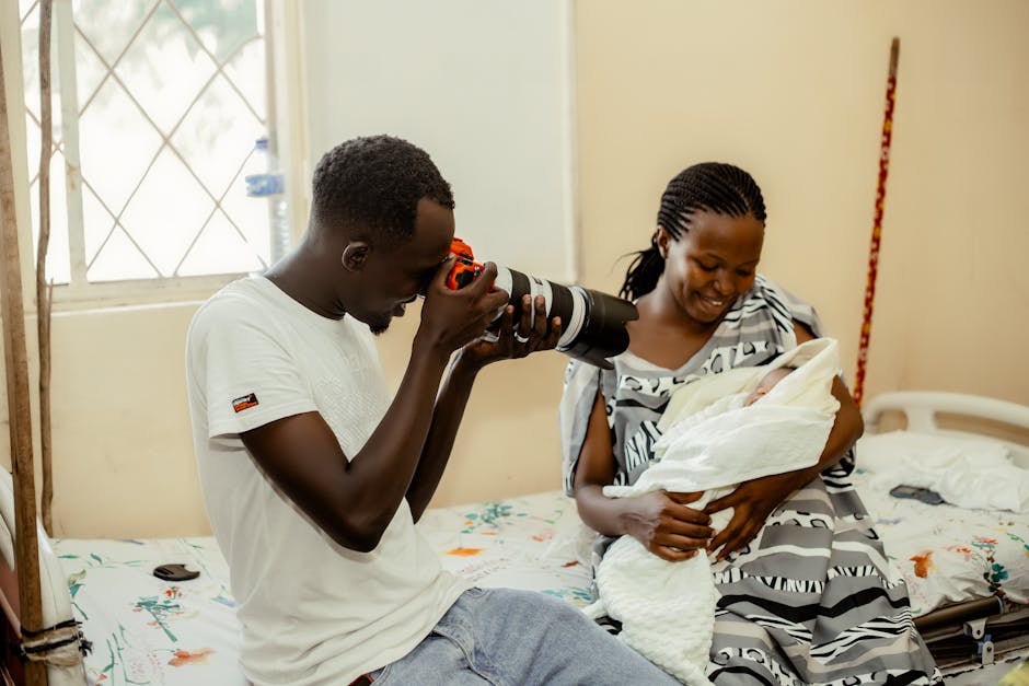 A photographer working with an alert older newborn during a photo session