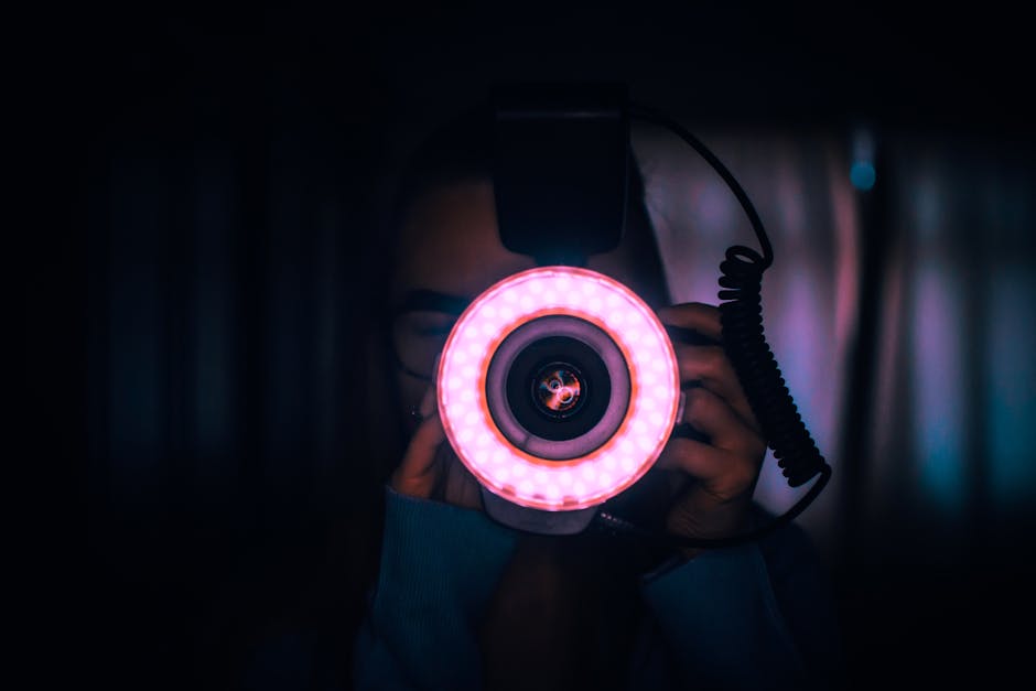 Photographer using an external flash unit to illuminate a subject in low light