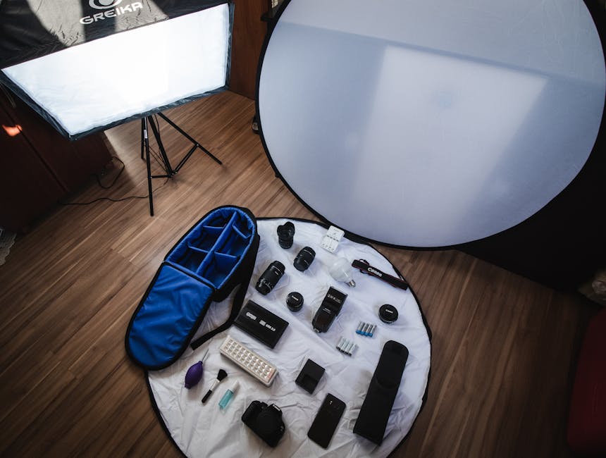 A collection of essential product photography tools including a camera, lighting equipment, and styling props