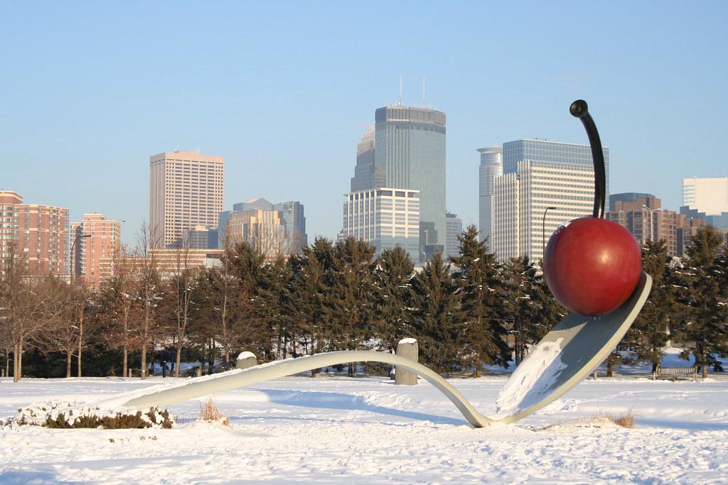 Iconic Spoonbridge and Cherry sculpture in Minneapolis Sculpture Garden with cityscape in background