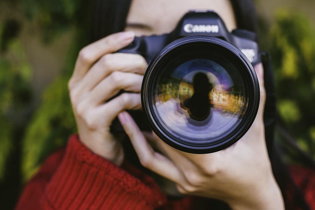 A skilled photographer from Grey Bug Photography capturing a pivotal moment at an event, utilizing their expertise, advanced equipment, and unique perspective to create a stunning, emotionally resonant image that tells a compelling story and engages the audience.